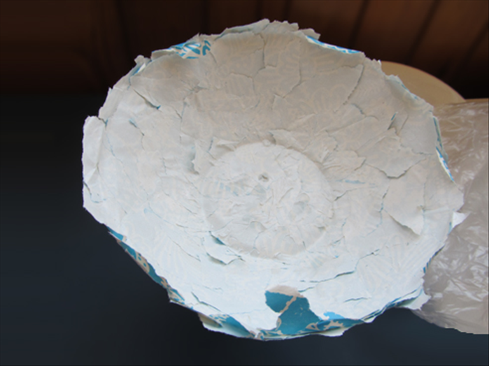Open the folds you just made.
Carefully remove the paper from the bowl.
