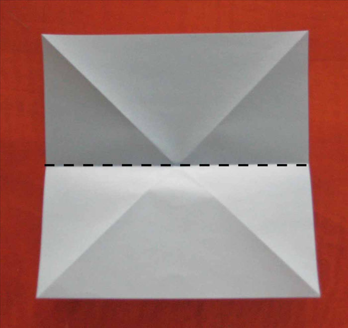 Flip the paper over to the back side. 
Fold the paper in half horizontally and unfold