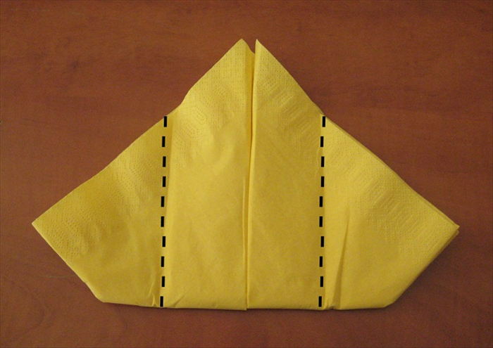 Flip the napkin over to the other side.

Fold the side points slightly past the center. See next picture for results.