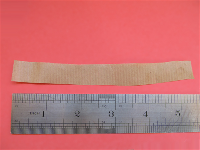Cut a strip of paper 5 ½ X ½  inches for the band