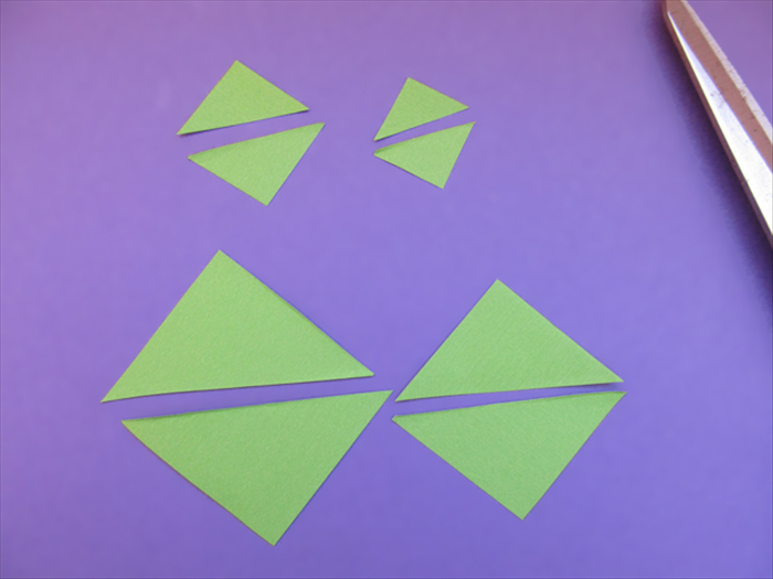Cut the squares in half along the crease line.
You will have 8 triangles.
