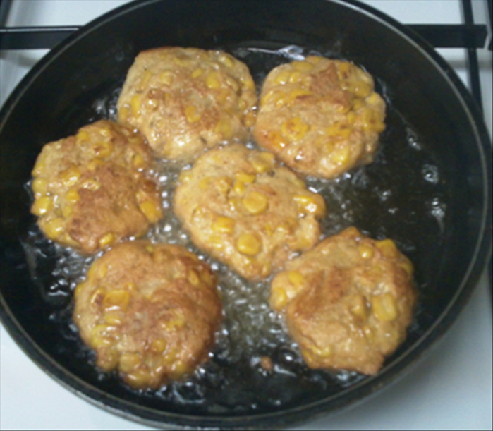 Fry the patties in oil over medium low heat until golden brown on the bottom 
then flip them over and fry the other side until golden brown

Drain the oil on paper towels and serve

Bon Appetite! 
