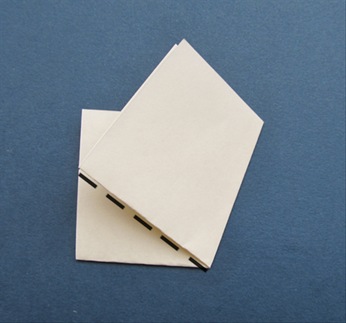Fold the left side up along the left bottom edge of the flap you just folded.