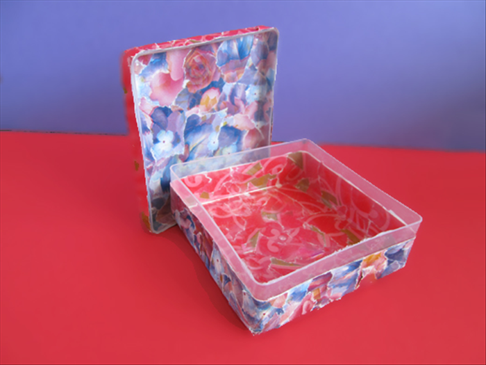 Materials:
Empty Q-tip box or similar plastic box with a removable lid
Scrap paper, magazines or junk mail
Paper glue stick
Scissors
