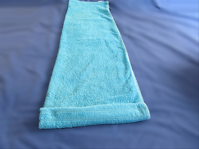 Rotate the towel so that the short edge is closest to you.
Make a small fold at the short edge and roll the towel up tightly.
