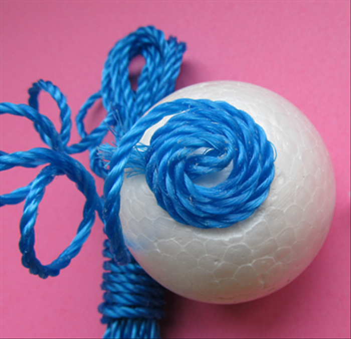 Glue the wound cord to the ball. 
Let the glue dry completely.